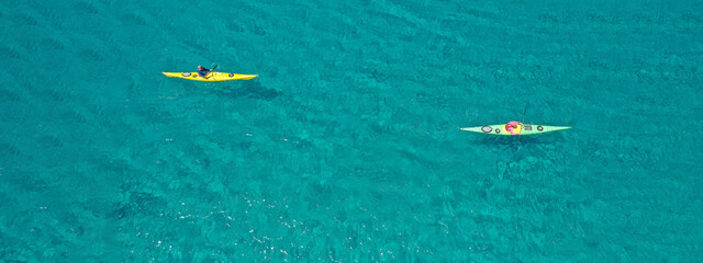 Aerial drone ultra wide panoramic photo with copy space of unidentified caucasian women paddling on...