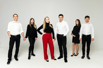 group of young people on a white background. brothers and sisters. company of friends in formal wear on a white background