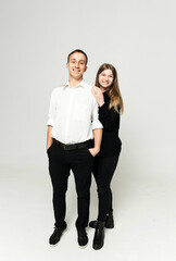loving young couple on a white background. a guy with a girl of twenty-five years old. lovers stand in full growth on an isolated white background.