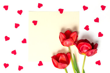Red tulips with a red heart.Valentine's Day background.Top view on white