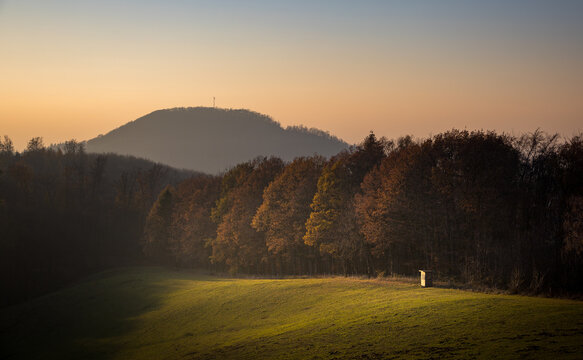 Colorful autumn sunset in Odenwald, Germany, with Melibocus in the background