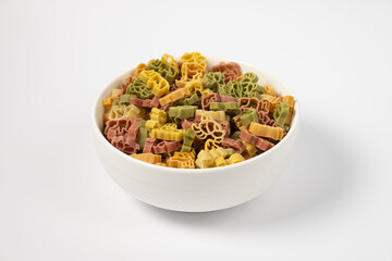 Pasta trottole tricolore wheat in a plate isolated on white background