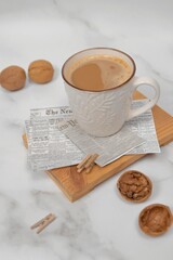 cup of coffee with nuts and newspaper