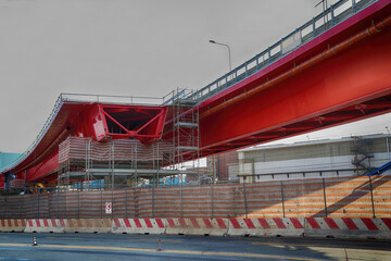 Bridge construction with scaffolding forms over intersection road. Construction and infrastructure development concepts