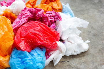 Colorful plastic bags on cement floor