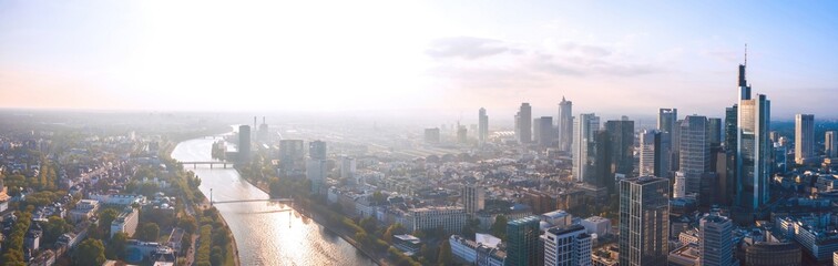 Wide panoramic aerial cityscape of Frankfurt am Main, Germany. Skyline panorama of the Bankenviertel financial centre skyscrapers at sunset. - obrazy, fototapety, plakaty