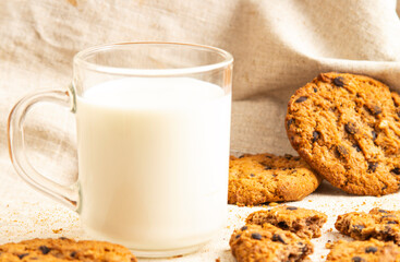 Milk and chocolate chip cookies on gray cloth