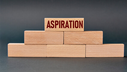 ASPIRATION - word on wooden blocks on dark background