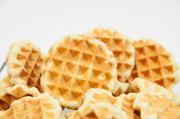 Belgian waffles on a table. holiday cookies on a white background. fresh baking concept. sweet desserts on a light texture