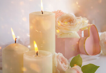 blurred bokeh valentine's day background with candle lights,roses and a pink heart-shaped box. 