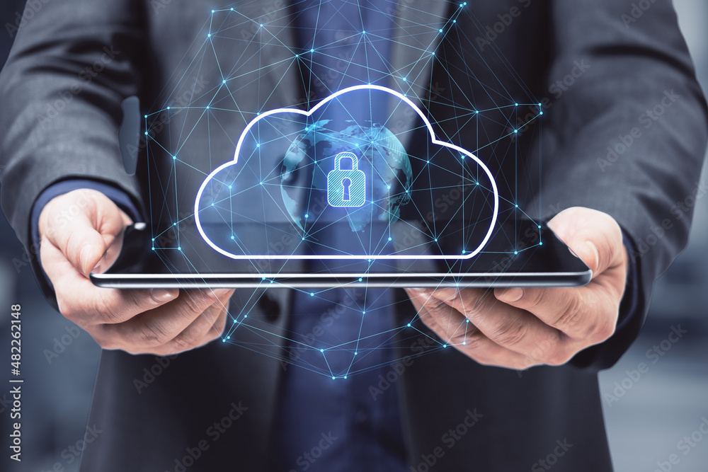 Poster close up of businessman hand holding tablet with abstract glowing cloud hologram with globe and safe