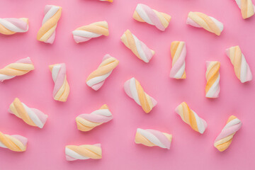 Colorful marshmallows on pastel background.