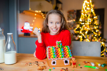 Adorable little girl baking Christmas gingerbread cookies