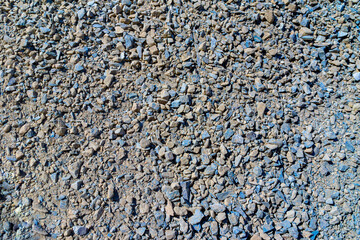 a mixture of bluish slate crushed stone and yellow or brown limestone crushed stone, fine and medium fractions, selective focus