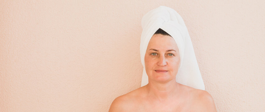 Portrait Of Middle-aged Woman With Towel On Her Head, No Makeup Positive Emotions. Facial Skin Care Cosmetic Procedures