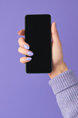 Manicured womans hands holding smartphone with blank screen