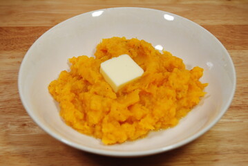 A Bowl with Mashed Butternut Squash with a Pat of Fresh Butter