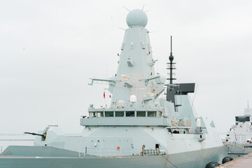 Warship with many locators gun turret have arrived in harbour. Naval. Defence. Protection. Army....