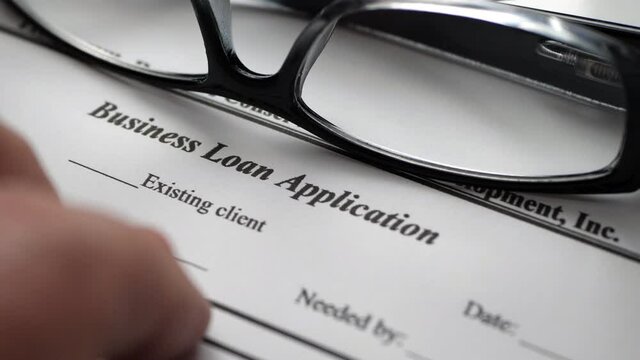 Finger tapping on business loan application