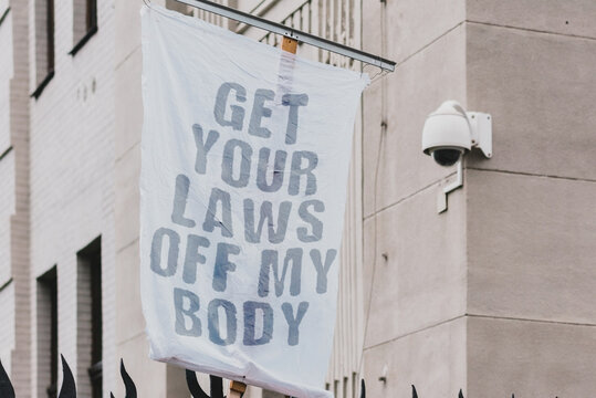 The phrase " Get your laws off my body " drawn on a banner and hangs on the building. Protest. Street. Law and justice. Social issue. Prevention