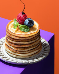 Pancakes with berries and chocolate sauce