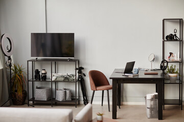 Background image of minimal home workplace with loft design elements and filming equipment, copy space