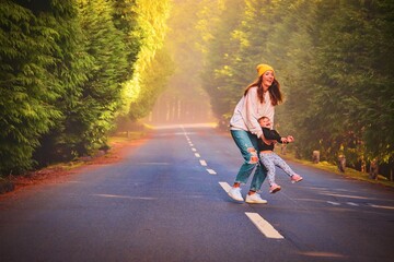 mother with her child is playing in the forest 