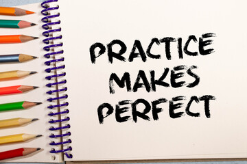 practice makes perfect - a motivational reminder on a green stocky note against grained wood,