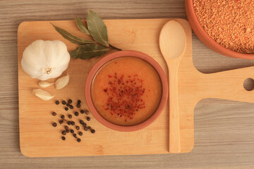 Making of Turkish traditional tarhana soup. Tomato paste, onion, garlic, parsley, salt, black pepper, olive oil. Overhead shot.