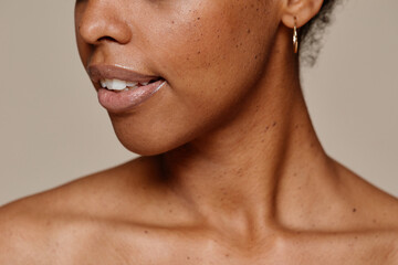 Close up portrait of young African-American woman demonstrating beautiful natural skin and white teeth smile, copy space - obrazy, fototapety, plakaty