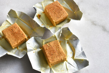 A top view image of three chicken flavored bouillon cubes used for seasoning. 