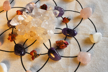 A close up image of a crystal healing grid with clear quartz cluster and amethyst crystals.