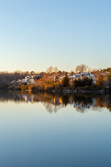 Houses by the Cary Lake Park under golden light sunset on a winter day
