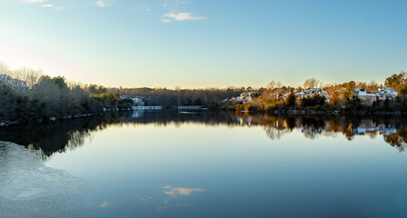 Houses by the Cary Lake Park under golden light sunset on a winter day