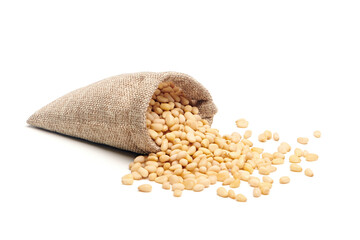 Siberian, Peeled pine nuts in burlap bag isolated on white background. Healthy nuts snacks....