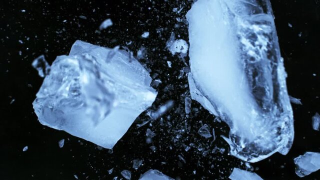 Super slow motion of falling piece of ice on black background. Filmed on high speed cinema camera, 1000 fps.
