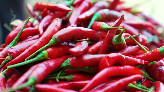 Close up of heap of spicy red chillies in abundance for sale at street marketplace