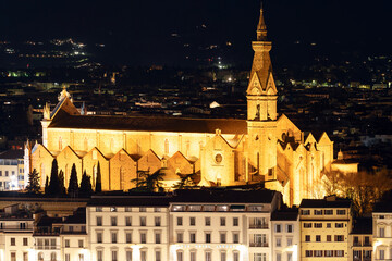Fototapeta na wymiar Night panoramic view of Basilica Holy Cross, and illuminated buildings. Florence, Tuscany, 12 Jan 2022
