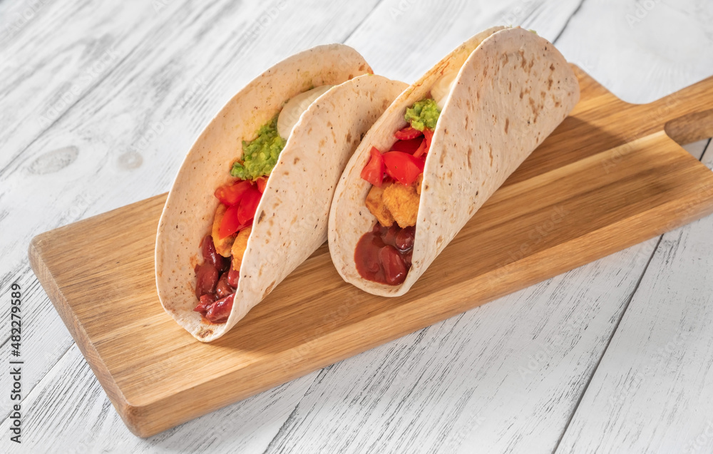 Wall mural taco with filling on the wooden background