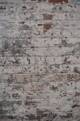 Peeling white painted brick wall