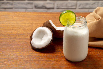 Smoothie coconut and lemon juice in glass cup with lemon slice