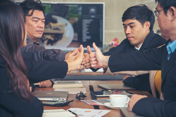 Group of diversity people fist bump holding hands together power of tag team. Teamwork Multiethnic people group working togetherness. Business people team holding hands successful. Business meeting