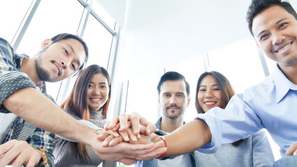 Group of diversity people fist bump holding hands together power of tag team. Teamwork Multiethnic people group working togetherness. Business people team holding hands successful. Business meeting