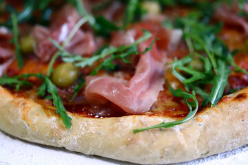 Selective focus. Pizza jamon and arugula. Italian pizza.