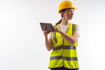 Architect with tablet. Woman architect in working uniform. Girl in yellow uniform of builder....