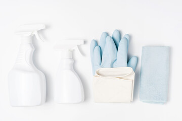 Detergent and a rag on blue background, the concept of spring cleaning.