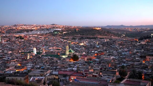 Aerial view of Fes city in Morocco residential district with old buildings and houses and clear sky during sunset