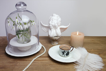 beautiful tender stilllife, snowdrop, Galanthus in vase, small cup of coffee, cappuccino, concept of coffeetime, romantic spring morning, floral spring background