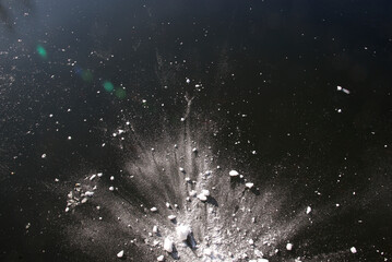 Winter abstract background. Snow hit the ice with a mighty splash. The texture of snow on the ice...