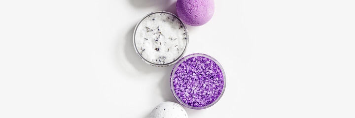 Obraz na płótnie Canvas Natural lavender bath bombs and sea salt with essential oil, spa products with dried lavender flowers. Natural cosmetic for beauty treatment and body care, herbal medicine, white background